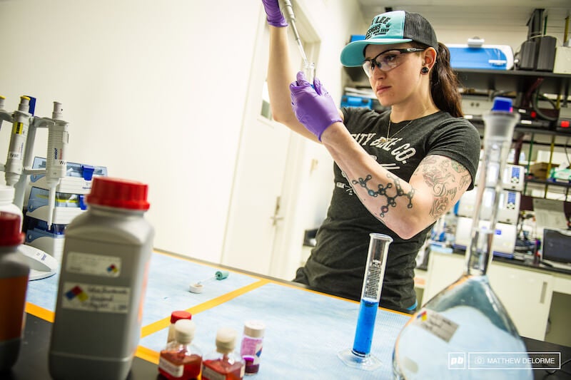 Anne Galyean injects liquid into a test tube in a science lab