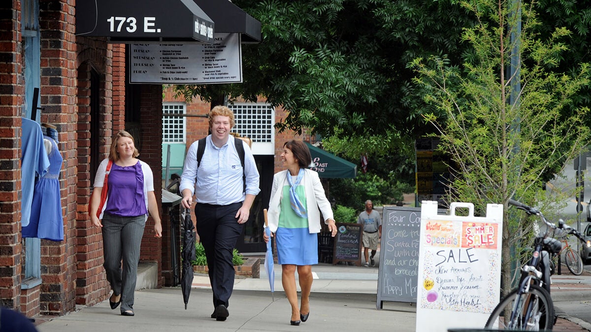 Chancellor Carol Folt and Christy Lambden walk on the sidewalk.