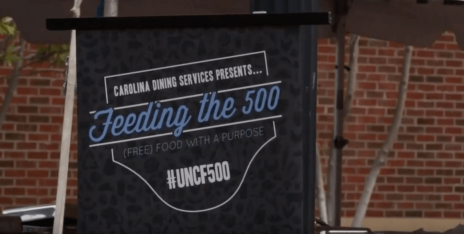 Sign that says Carolina Dining Service presents Feeding the 500 (free) food with a purpose