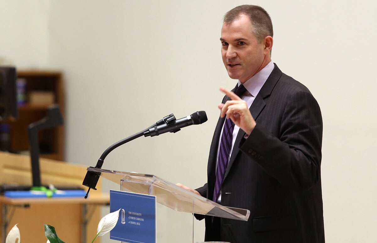 Frank Bruni speaks at a podium.