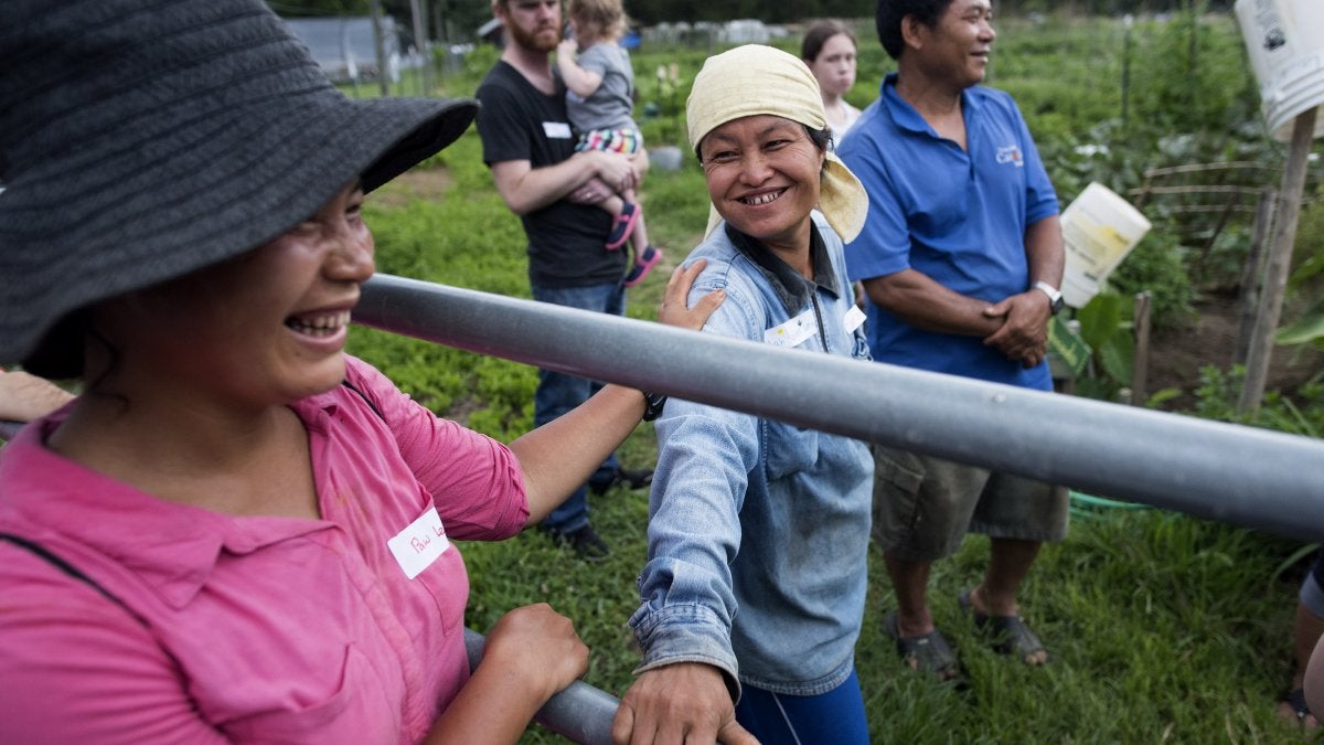 Refugees smile at each other.