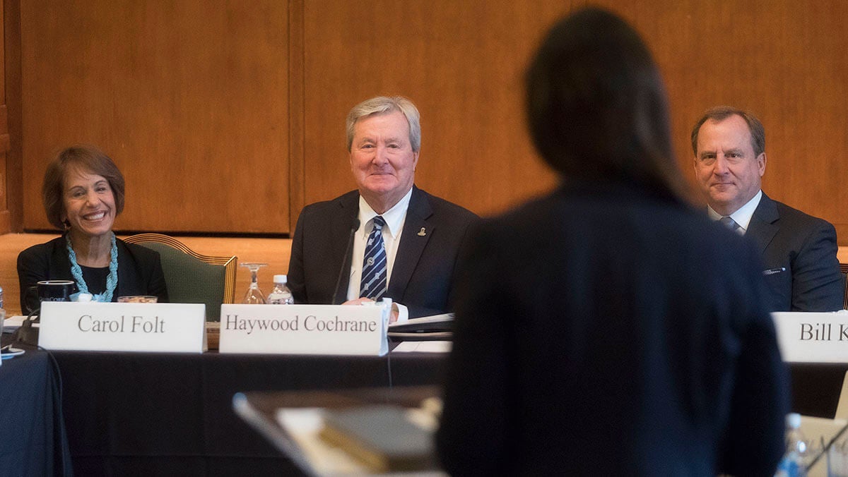 Board of Trustees listen to speaker.
