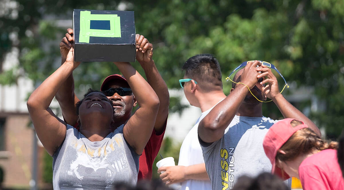 People view a solar eclipse