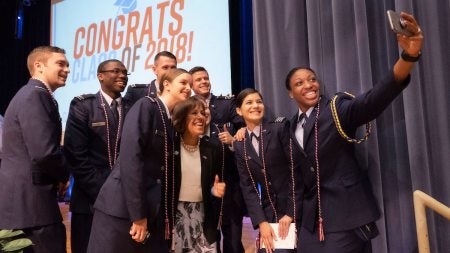 Students pose for a photo with Chancellor Carol Folt.