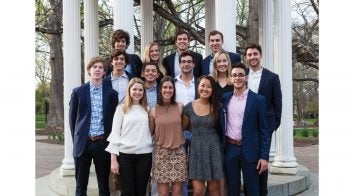 Students pose for a photo in front of the Old Well.