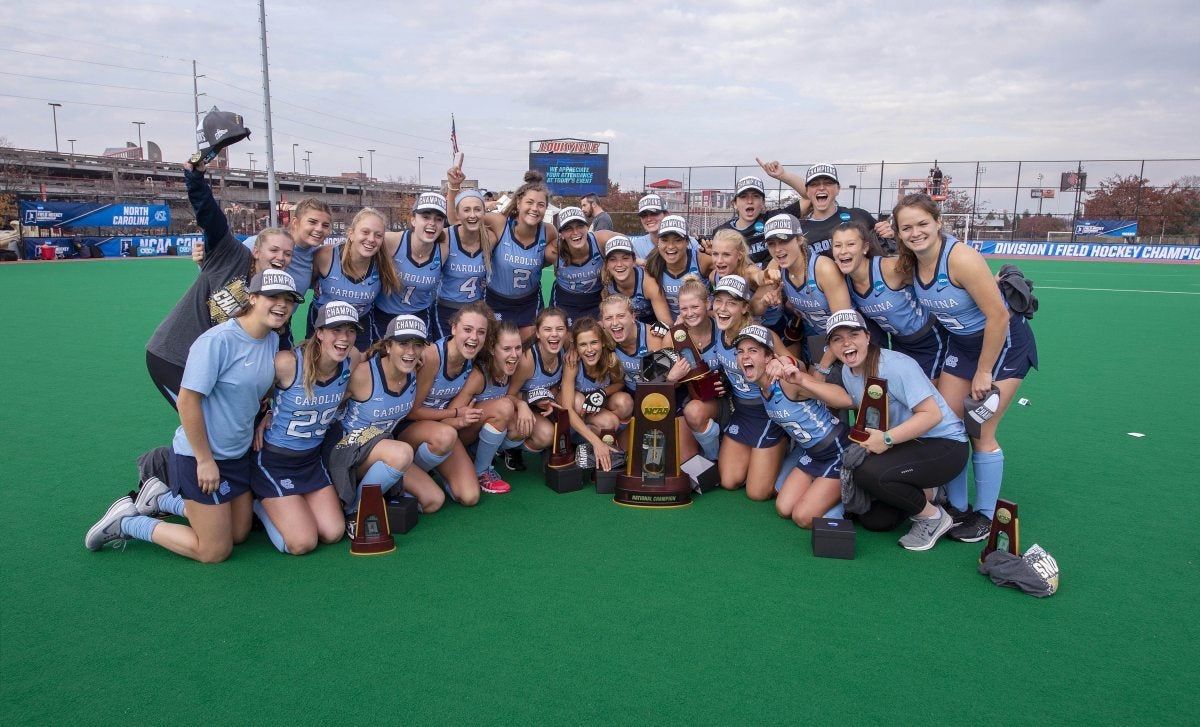 Members of the field hockey team pose with the 2018 NCAA championship trophy