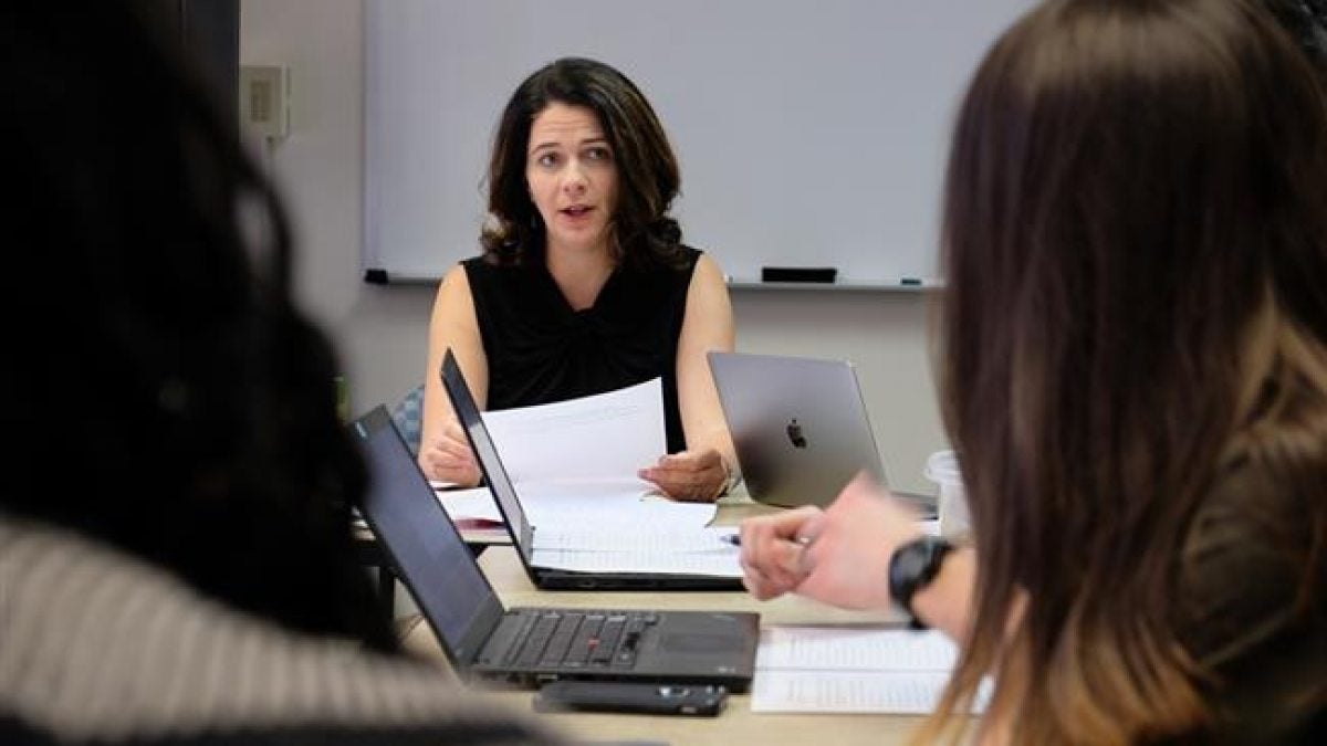 A faculty member lectures.