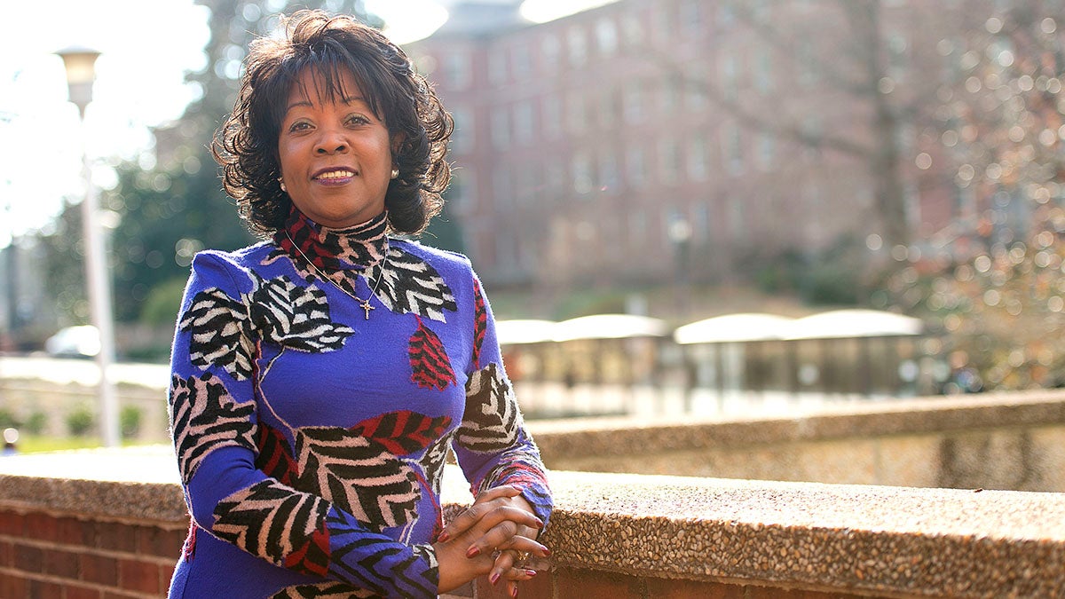 Rumay Alexander stands outside of the School of Nursing for a photo.