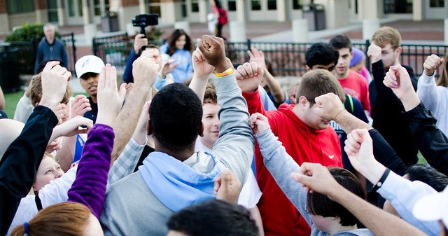 Students huddle for a cheer.