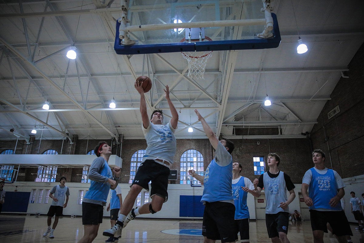 Men play basketball