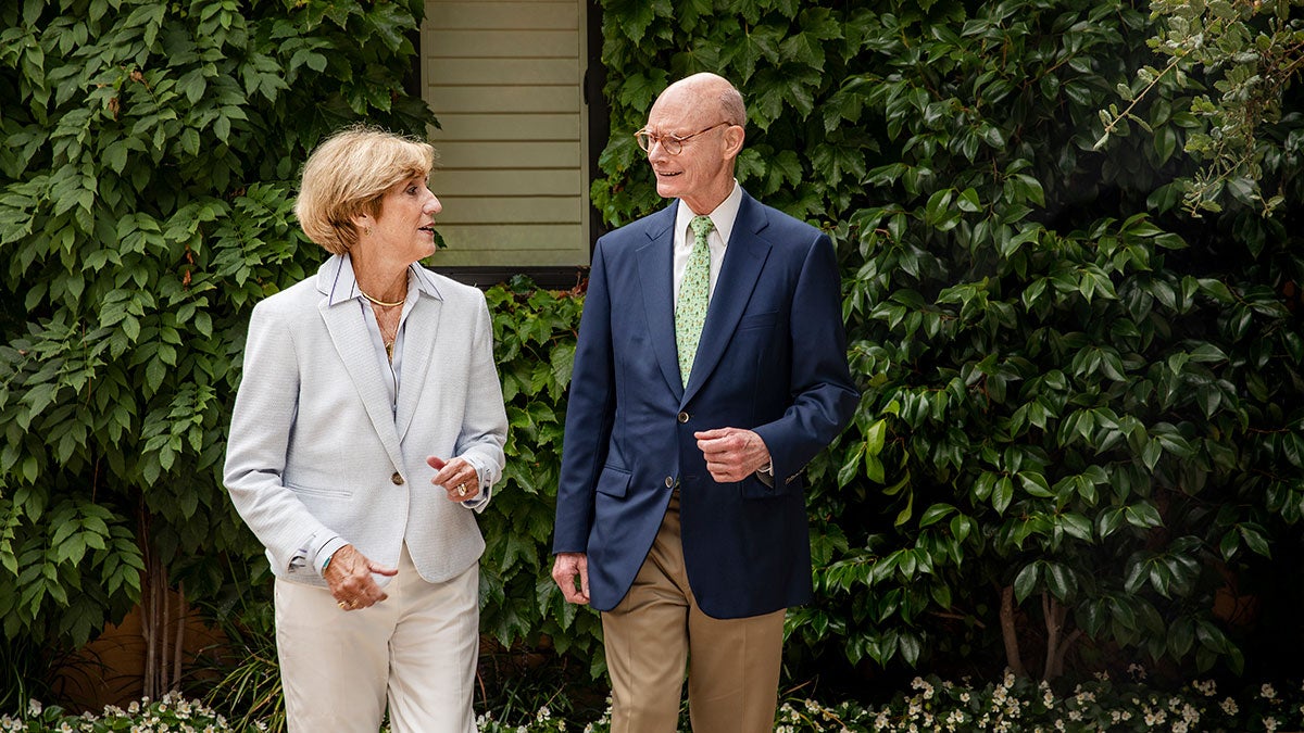 Susan King walks with Walter Hussman.