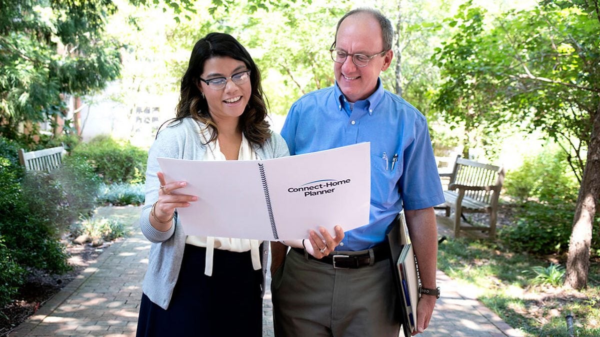 Mark Toles talked with a woman while reading a Connect-Homes book.