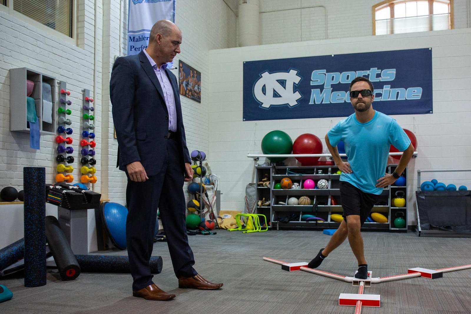 Jason Mihalik examines a patient who is testing their balance.