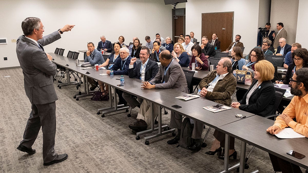 A group of faculty members listen to a presentation.