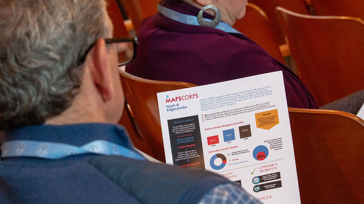 A Tar Heel Bus Tour participant reads a flyer about MAPSCorps.