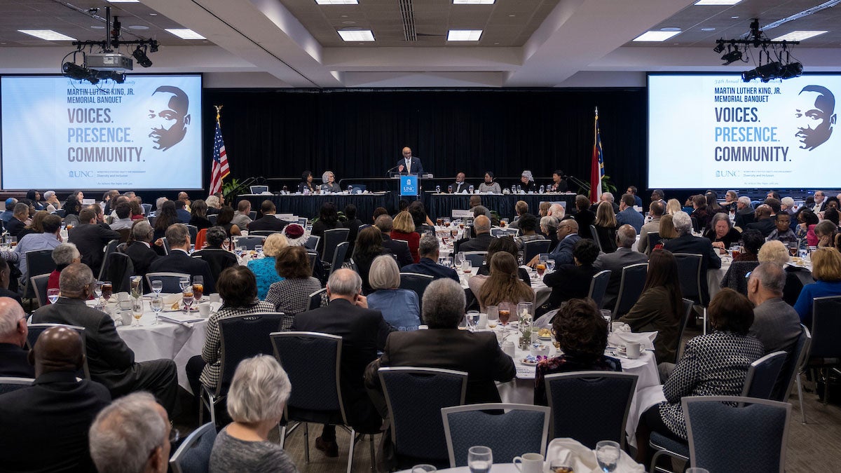 People listen to a speaker during a banquet.