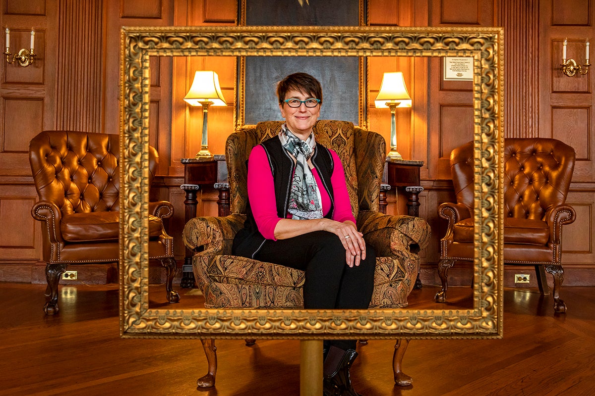 Barbara Fredrickson sits in a decorative chair in a lounge