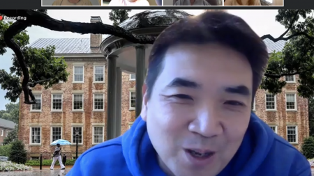 A man talks on a Zoom video call.