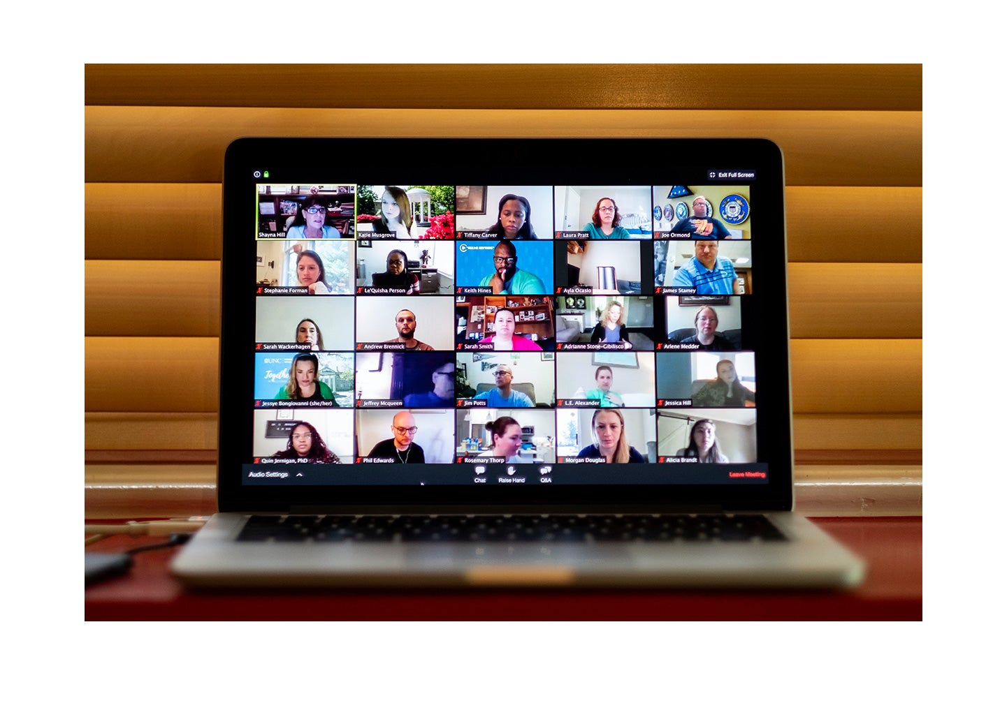 A photo of a zoom call on a laptop.
