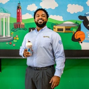 Antonio McBroom holds a milkshake at the Chapel Hill Ben and Jerry's shop.