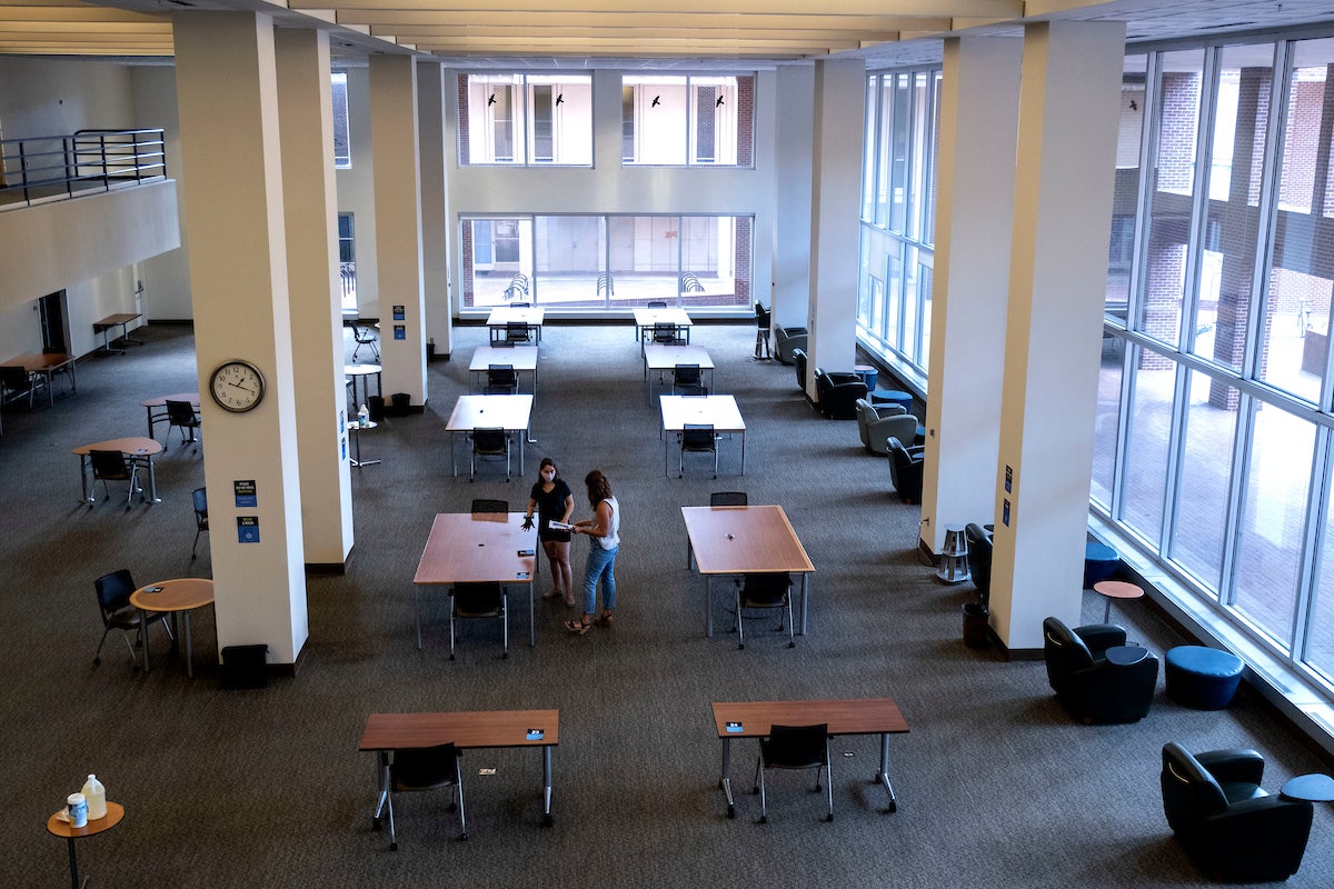Staff members clean in the library.