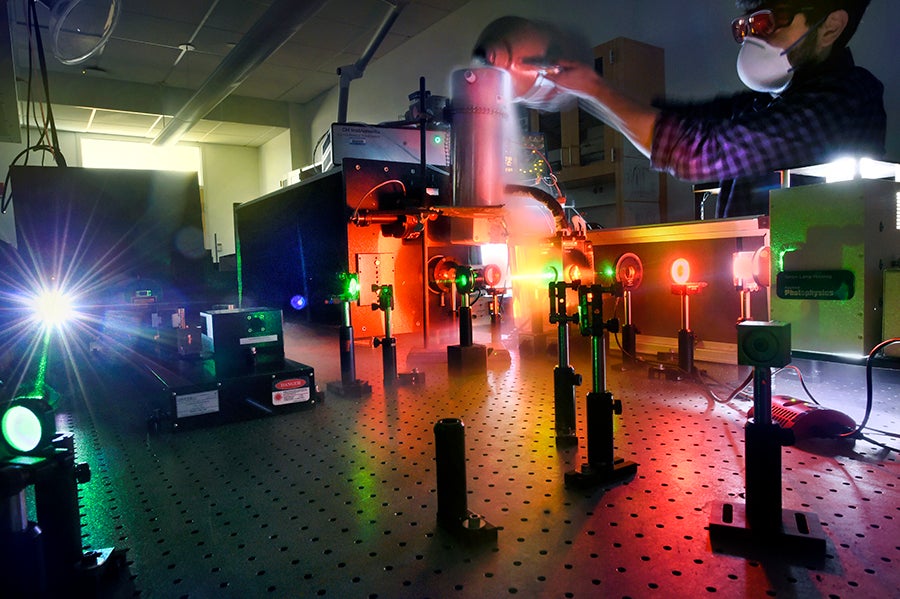 An experience using lasers is conducted on a table.