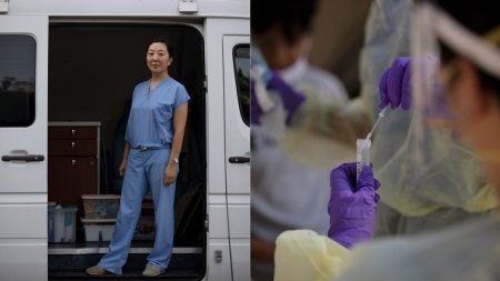 A woman stands in a mobile medical clinic.
