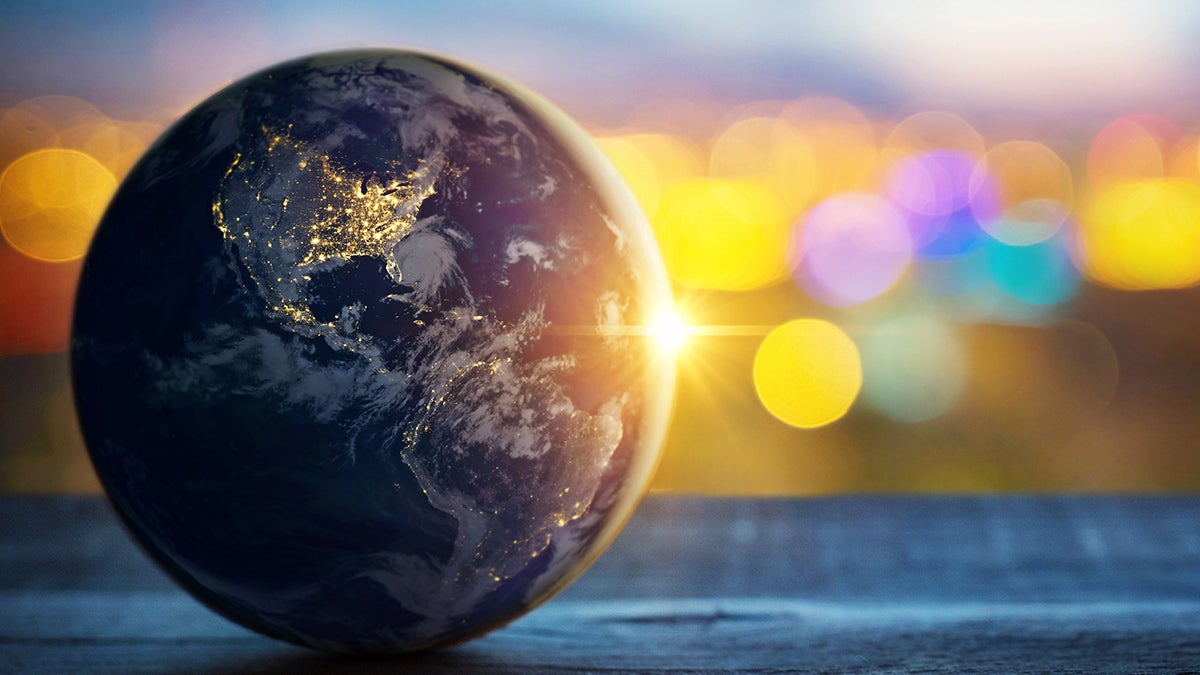A globe with a sunset behind it.