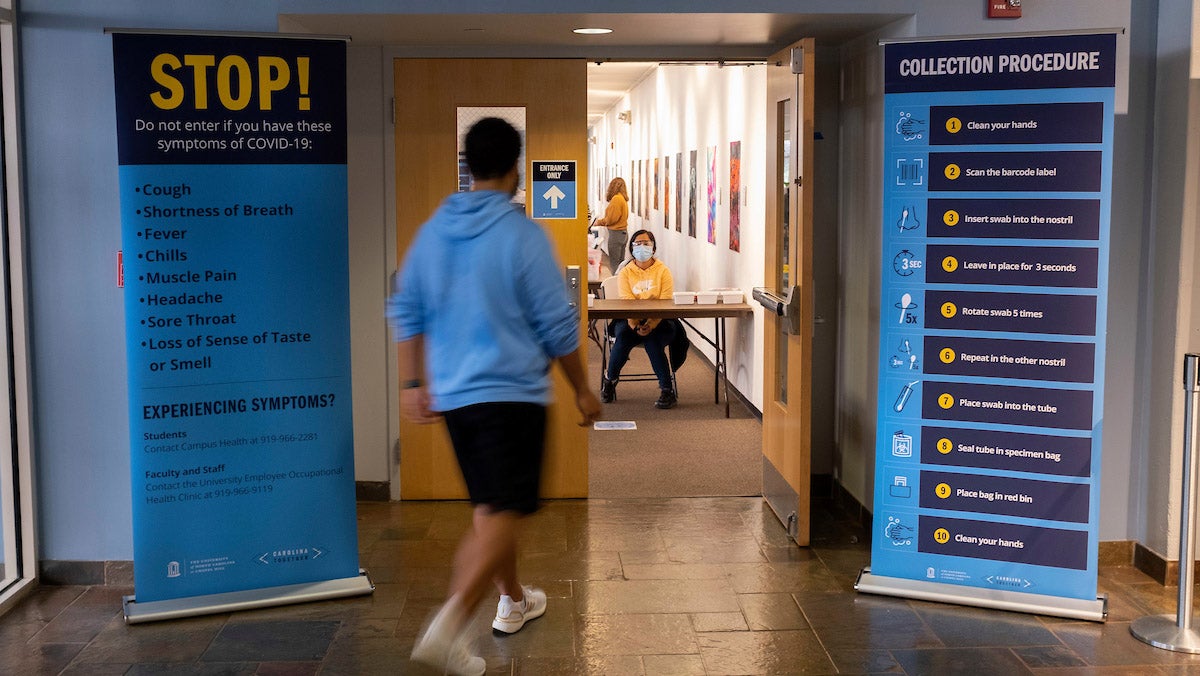 A student walks into a Carolina Together Testing site.