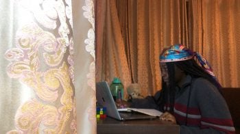 A student taking class on her laptop.