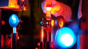 A person adjusts a laser tool.