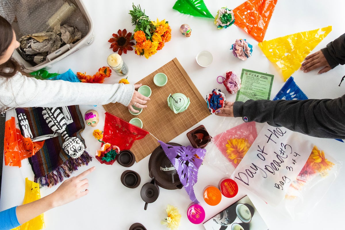 Students assemble culture kits on a table.
