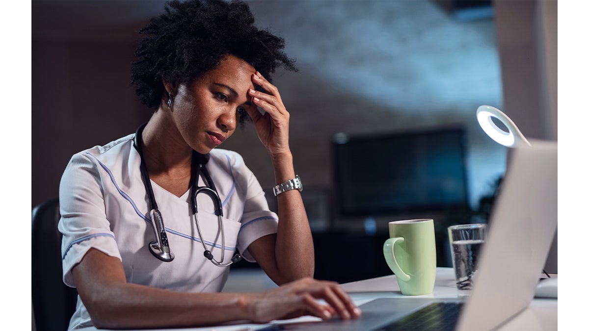 A health care worker at their desk.