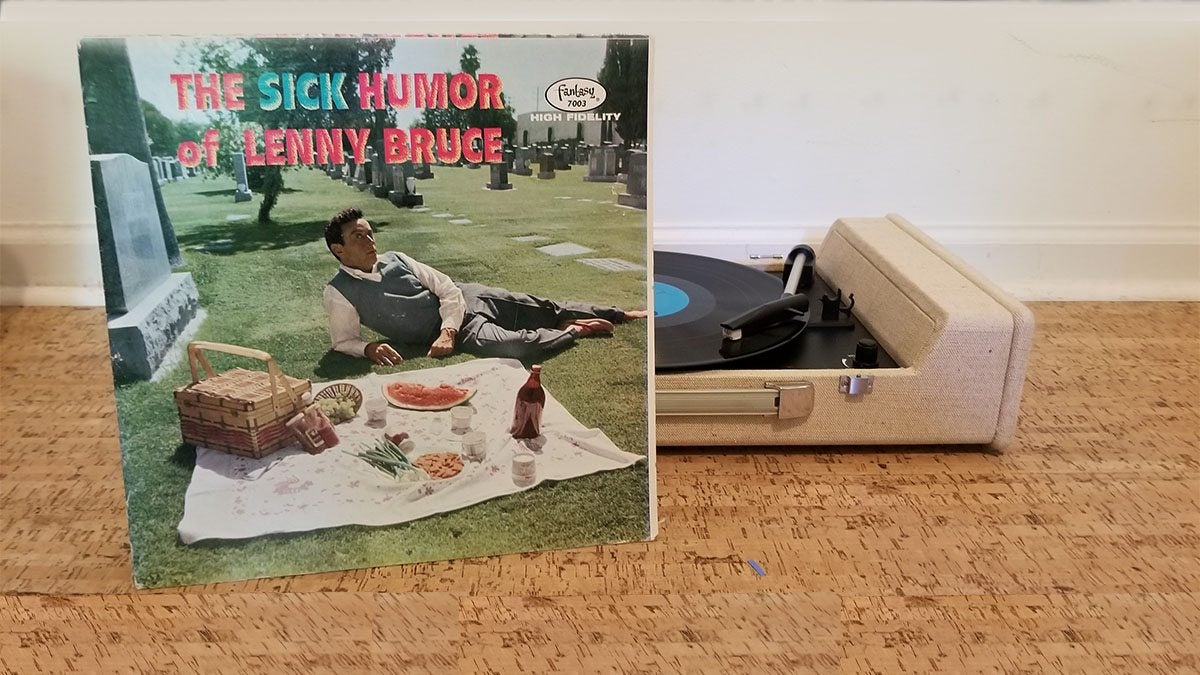A record leans against a record player.