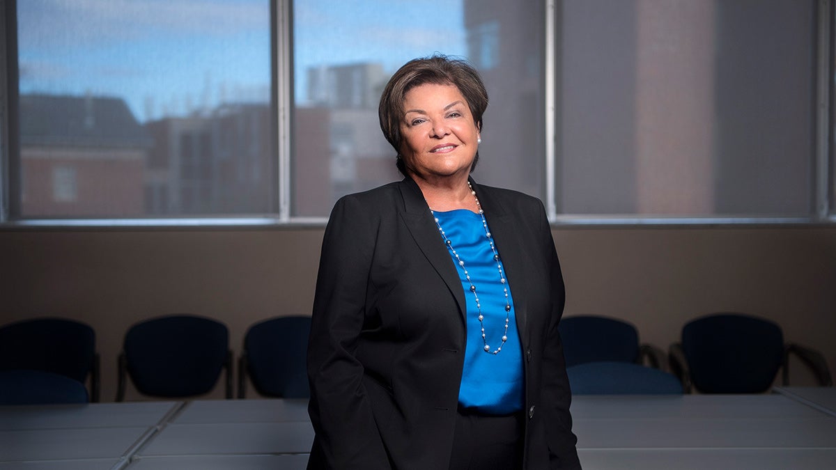 Nena Peragallo Montano stnading in a conference room.