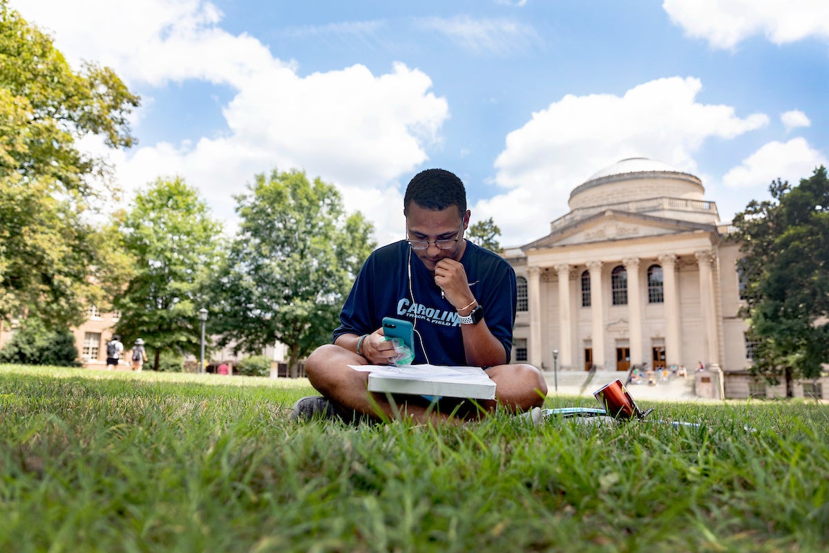 A student sitting on polk place.