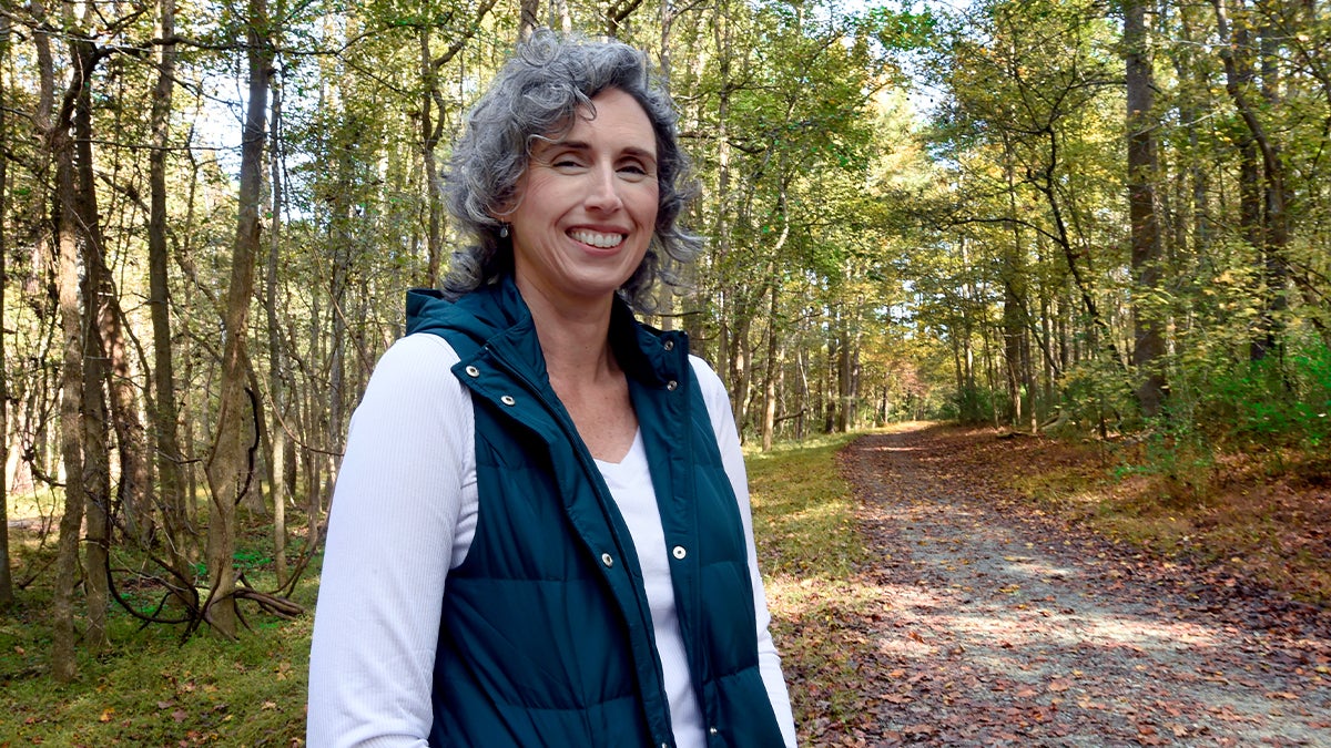 Jennifer Gates-Foster standing in the woods.