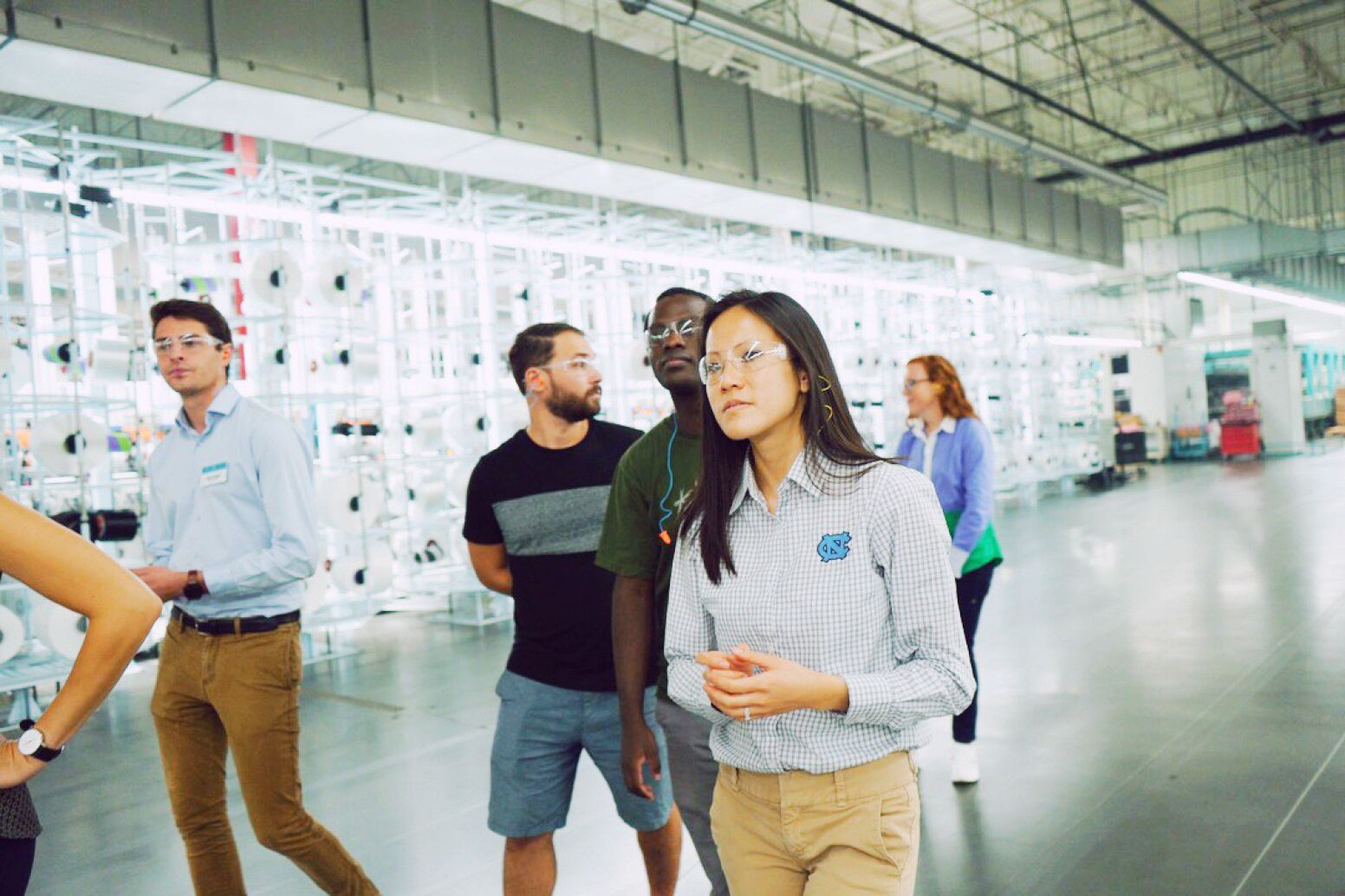 A woman walking in a warehouse.