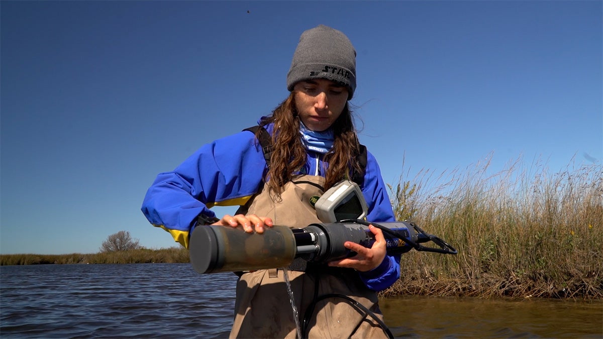A student conducting research at the coast.