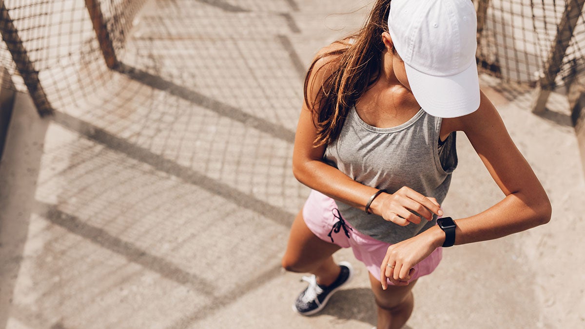 A person looking at a smart watch.