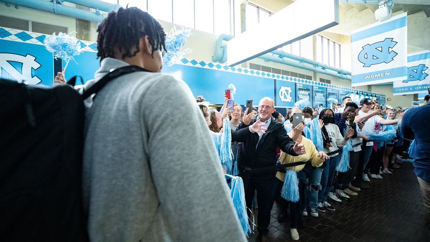 Player walking through a line of fans.
