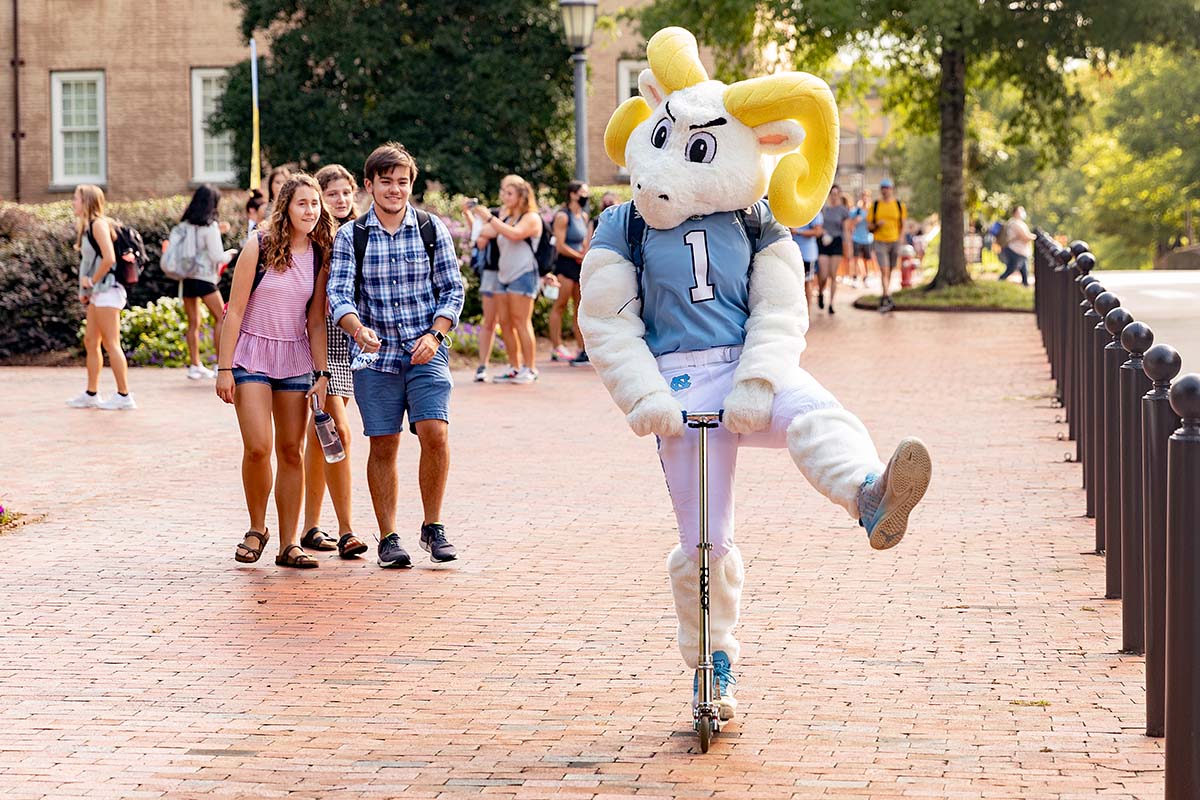 Rameses rides a scooter around campus on the first day of classes in 2021.