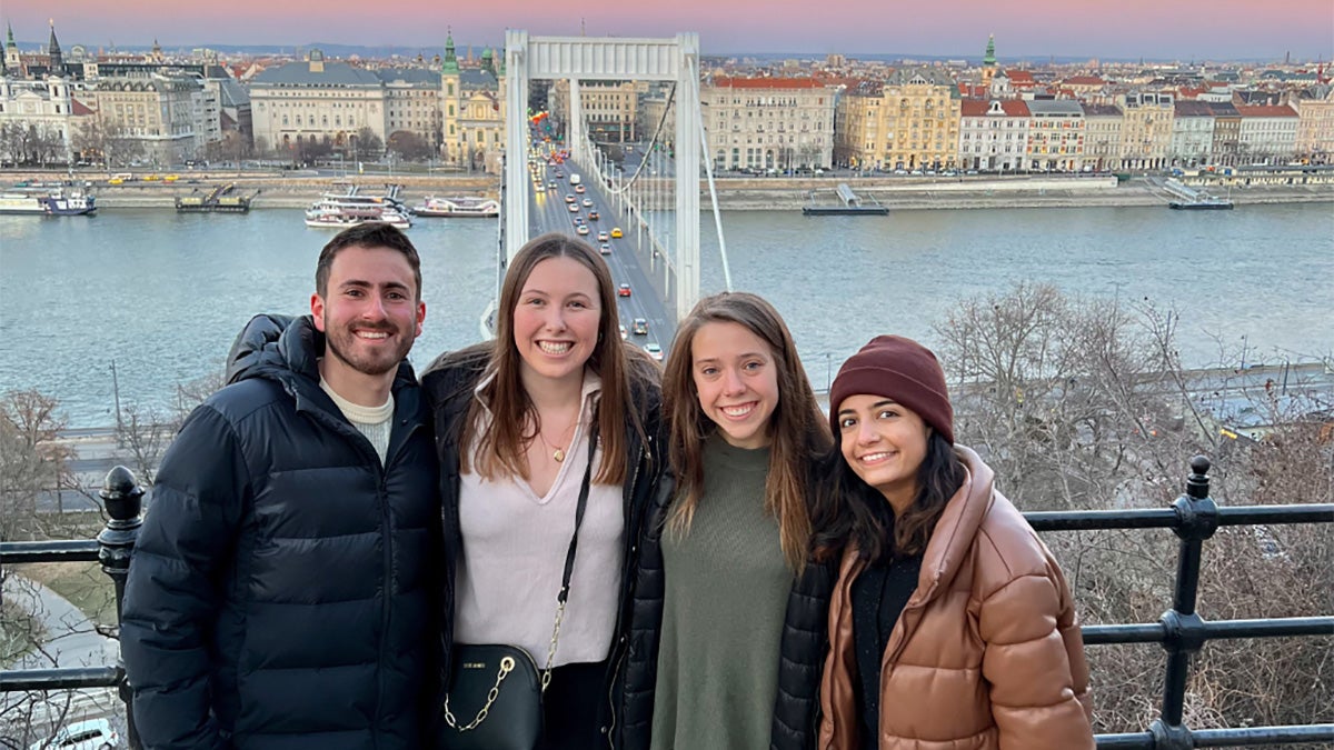 Four people pose for a photo together.