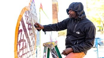 A person painting a mural.