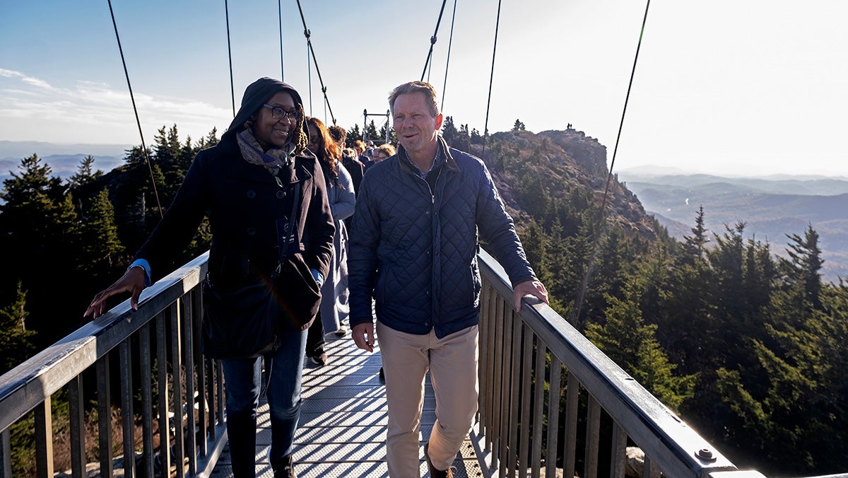 People walking across a bridge