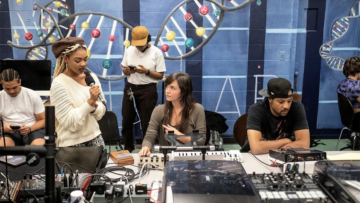 a class working with recording equipment.
