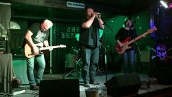 Rich McLaughlin, left, is professor and chair of the Department of Mathematics, but on stage he plays guitar in Magnolia Collective.