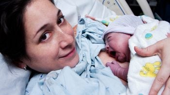 A mother holding a newborn baby