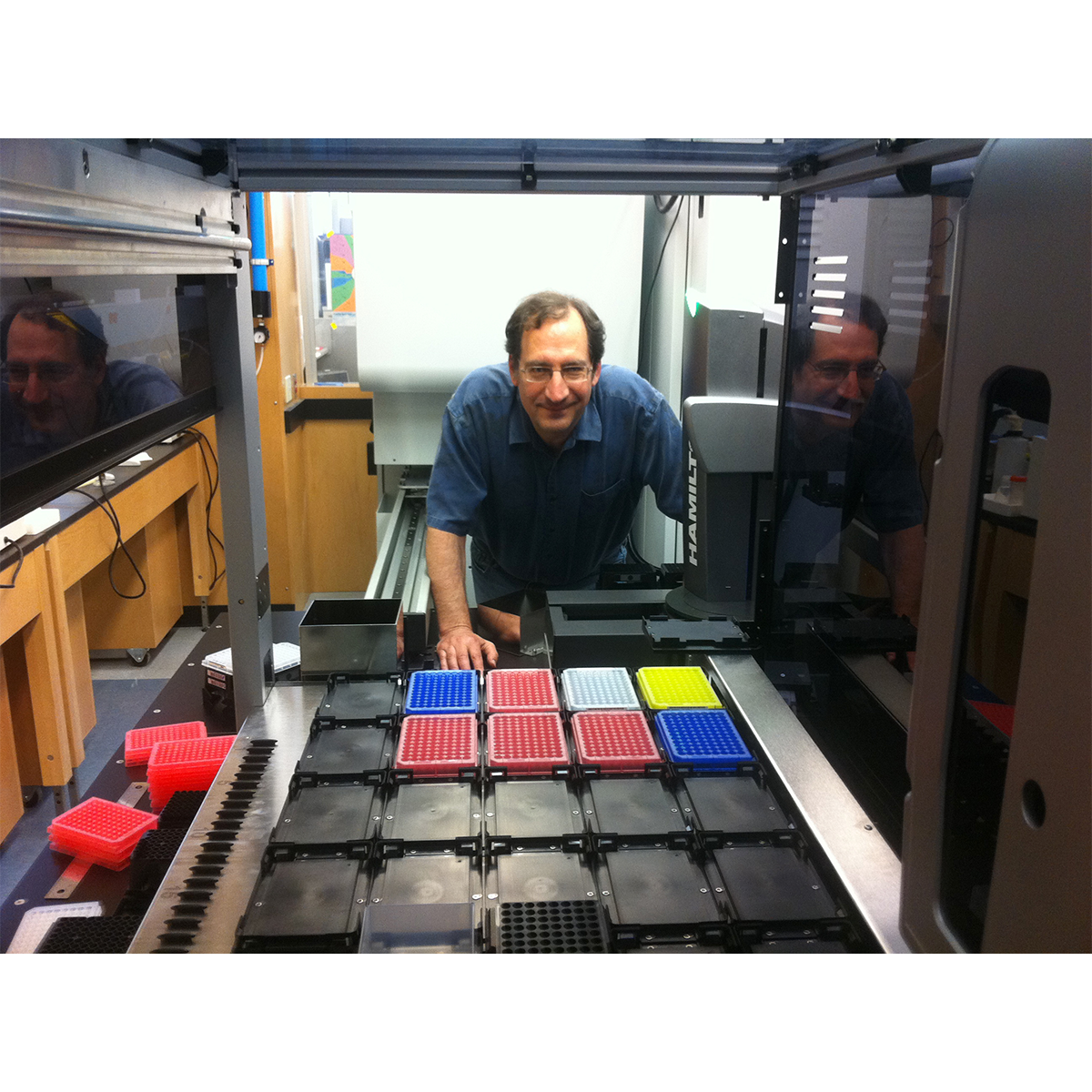 A man, Bryan Roth, posing for a photo in a lab.
