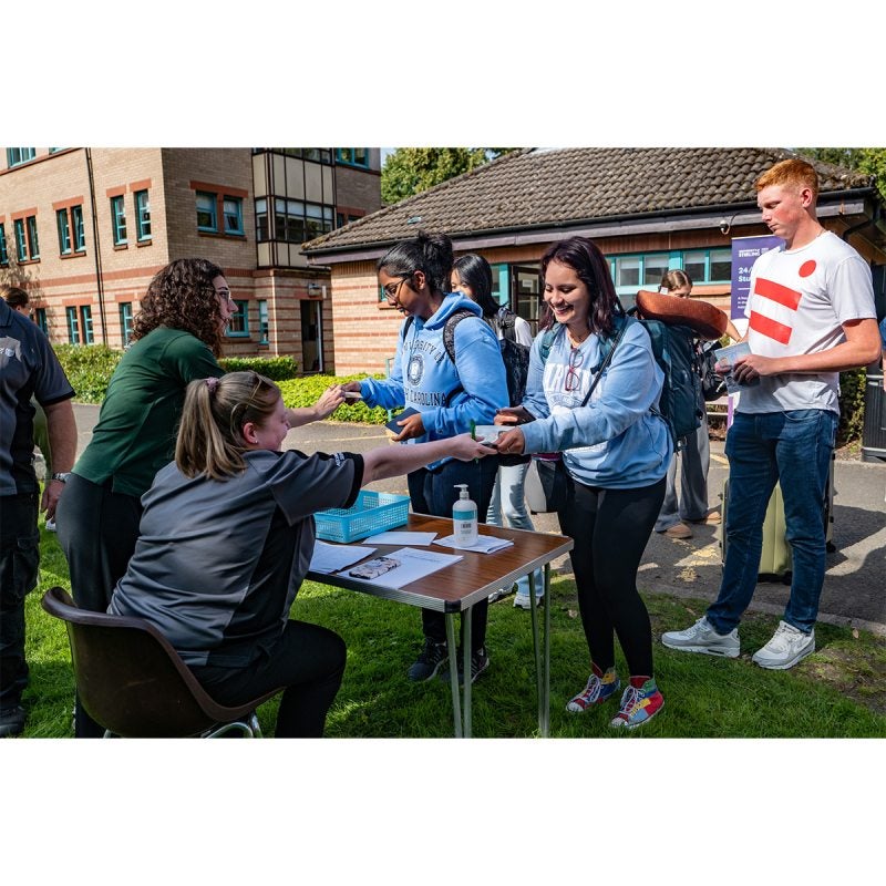 A student, Vanessa Ibarra, checking in for move-in and receiving information and materials at the University of Stirling.